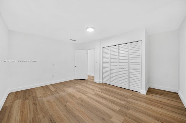 361 E 39th St, Hialeah, FL 33013 - unfurnished bedroom with light wood finished floors and a closet