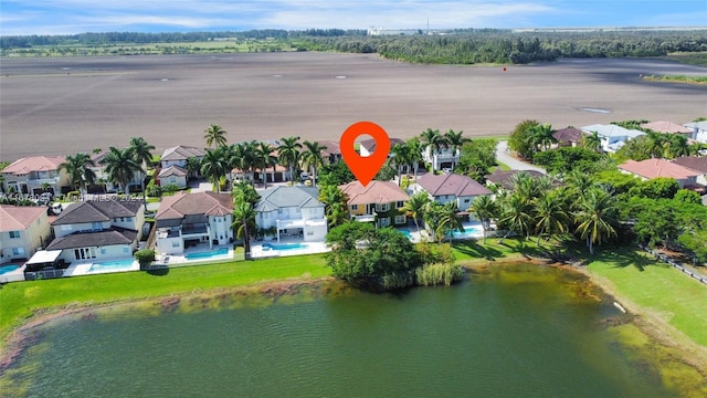 birds eye view of property featuring a water view and a residential view