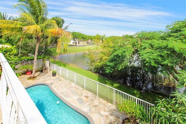 view of swimming pool featuring a fenced backyard, a patio area, a water view, and a fenced in pool