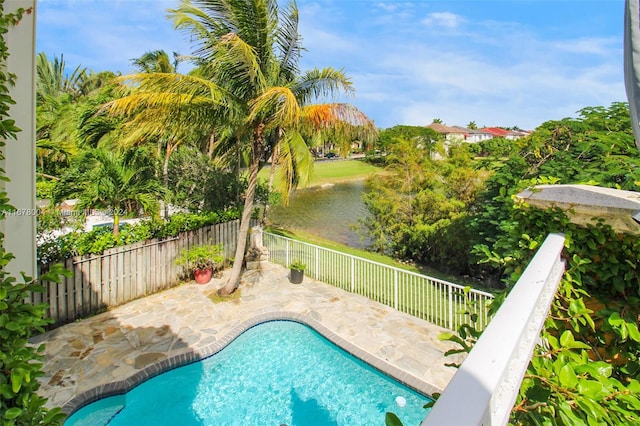 view of pool featuring a water view and a patio area