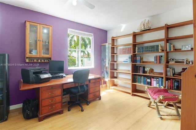 office area featuring a ceiling fan, baseboards, and light wood-type flooring
