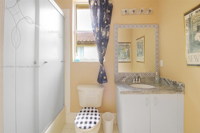 bathroom with walk in shower, tile patterned flooring, vanity, and toilet