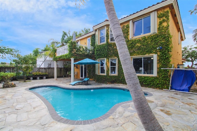 view of pool with a patio, a fenced in pool, and fence