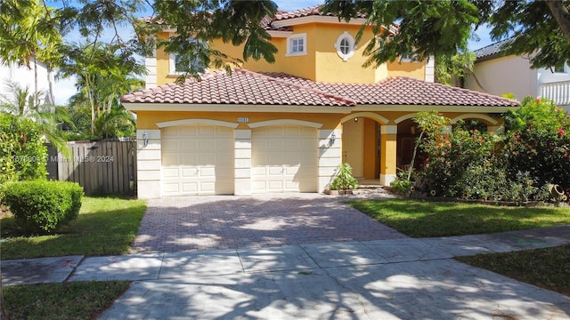 mediterranean / spanish-style home featuring stucco siding, decorative driveway, and a garage