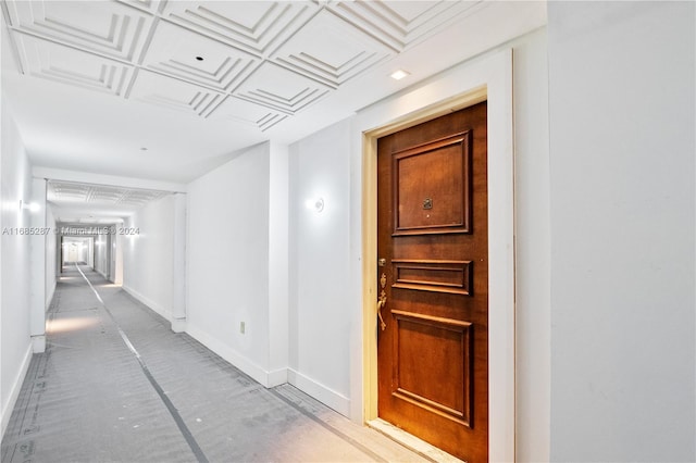 hallway featuring coffered ceiling