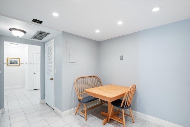 dining room featuring electric panel and light tile patterned floors