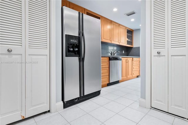 9801 Collins Ave Unit 18H, Bal Harbour, FL 33154 - kitchen with appliances with stainless steel finishes, glass insert cabinets, light tile patterned flooring, recessed lighting, and backsplash