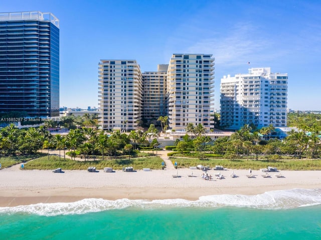 drone / aerial view with a beach view and a water view