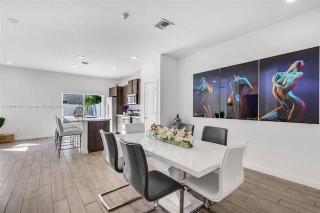 dining area with light hardwood / wood-style floors