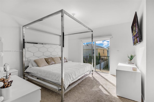 bedroom featuring access to exterior and carpet floors