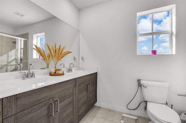 bathroom featuring walk in shower, tile patterned floors, vanity, and toilet