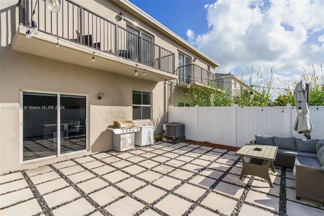 view of patio featuring central air condition unit, a balcony, outdoor lounge area, and grilling area