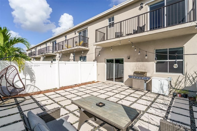 view of patio / terrace with a grill and a balcony