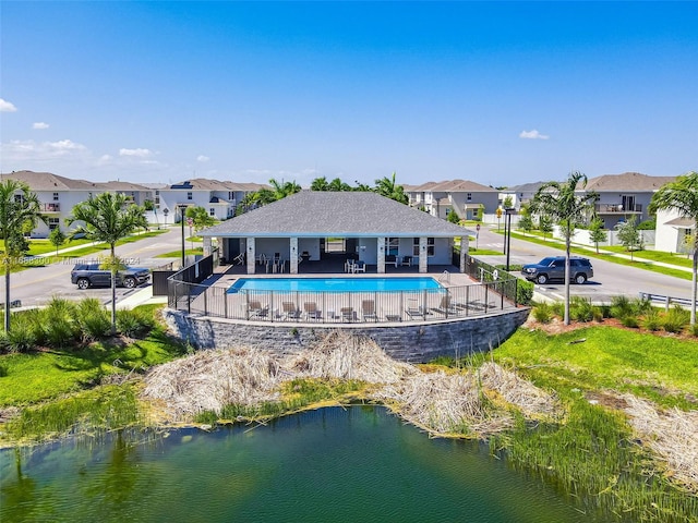 view of pool with a patio and a water view