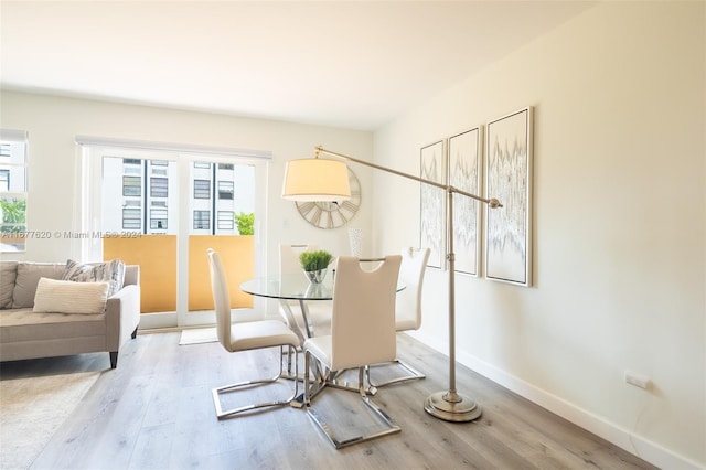 dining space featuring a healthy amount of sunlight and light hardwood / wood-style flooring