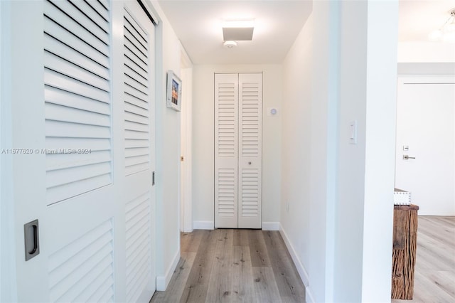 hallway with light wood-type flooring