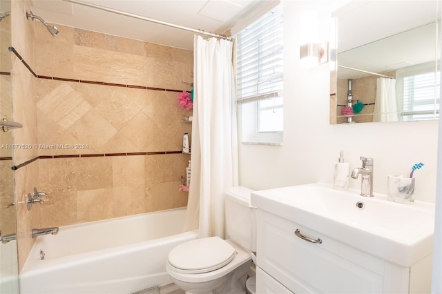 full bathroom with vanity, shower / bath combination with curtain, and toilet