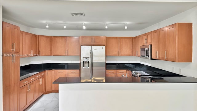 kitchen featuring stainless steel appliances and track lighting