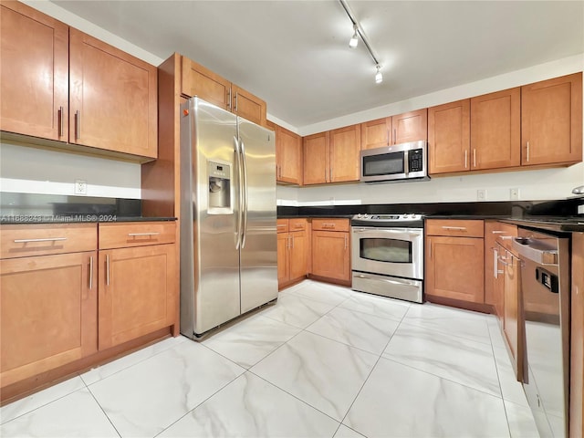 kitchen featuring stainless steel appliances and track lighting