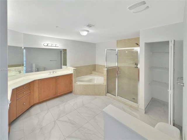 bathroom featuring vanity and independent shower and bath