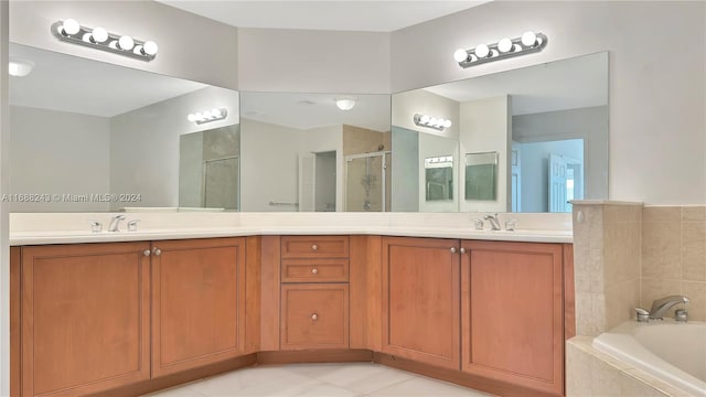 bathroom with tile patterned floors, vanity, and plus walk in shower