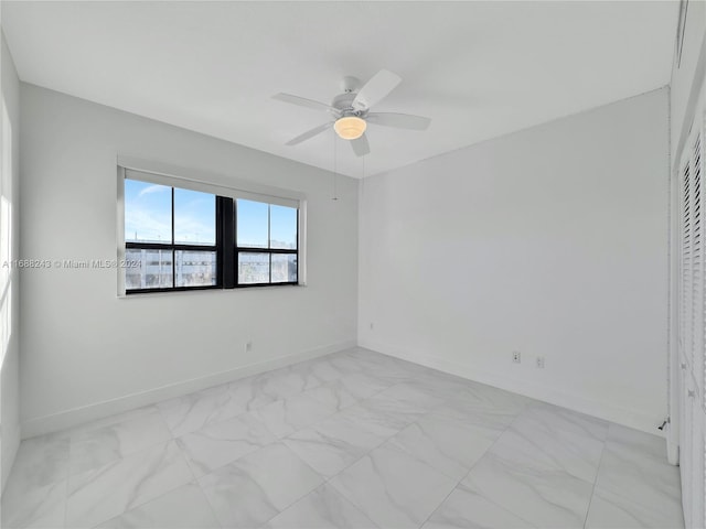 spare room with ceiling fan