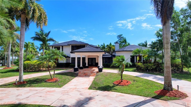 view of front of house featuring covered porch and a front yard