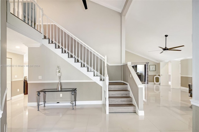 stairway featuring crown molding, tile patterned flooring, high vaulted ceiling, and ceiling fan