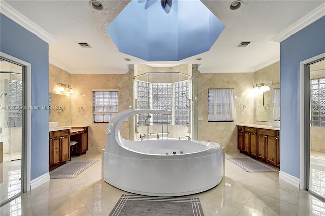 bathroom featuring vanity, shower with separate bathtub, ornamental molding, and a textured ceiling