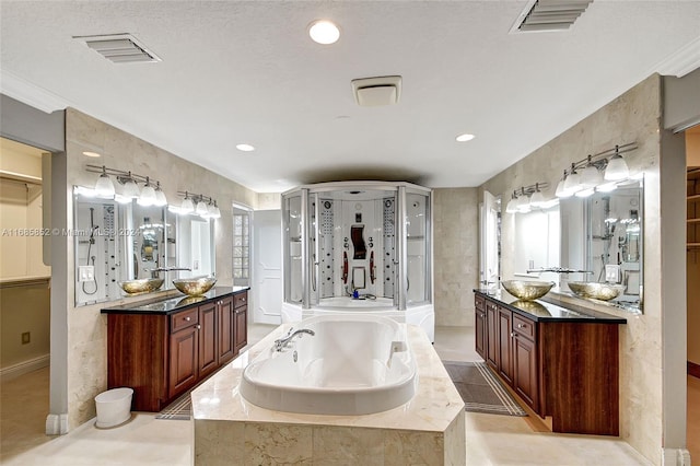 bathroom featuring vanity and independent shower and bath