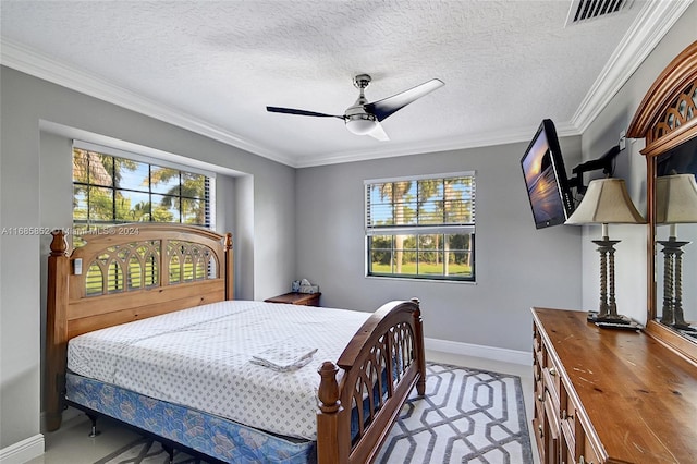 bedroom with a textured ceiling, ceiling fan, and crown molding