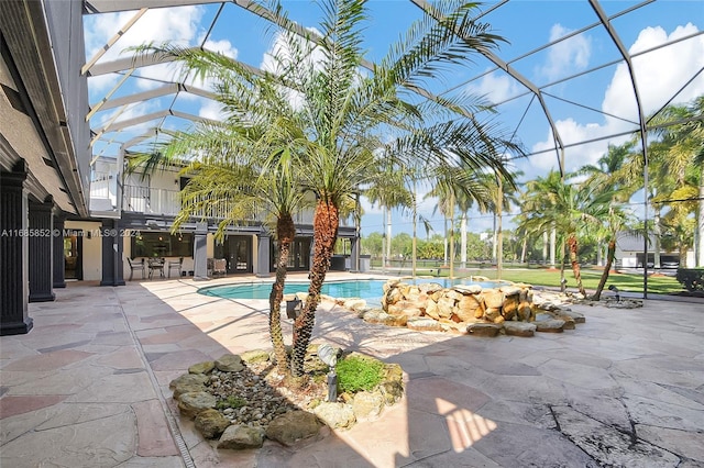 view of swimming pool featuring a lanai and a patio area