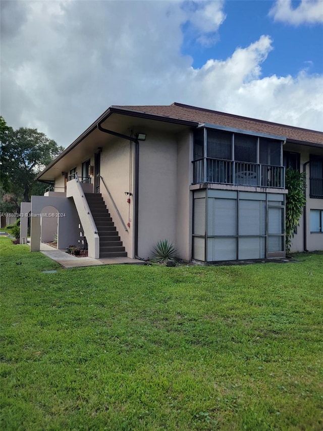 back of property with a lawn