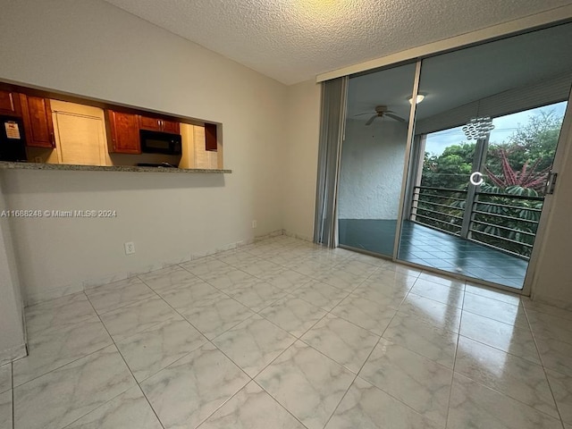 unfurnished room featuring a textured ceiling and ceiling fan