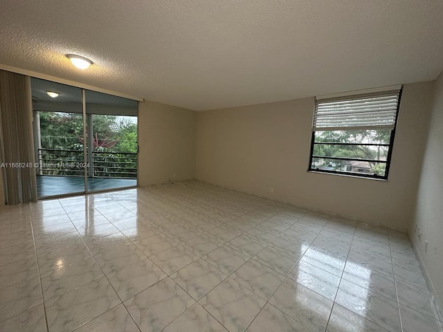 spare room with a textured ceiling