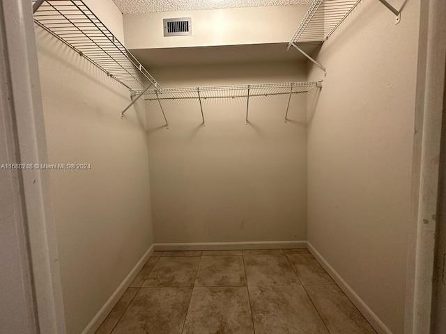 spacious closet featuring tile patterned floors