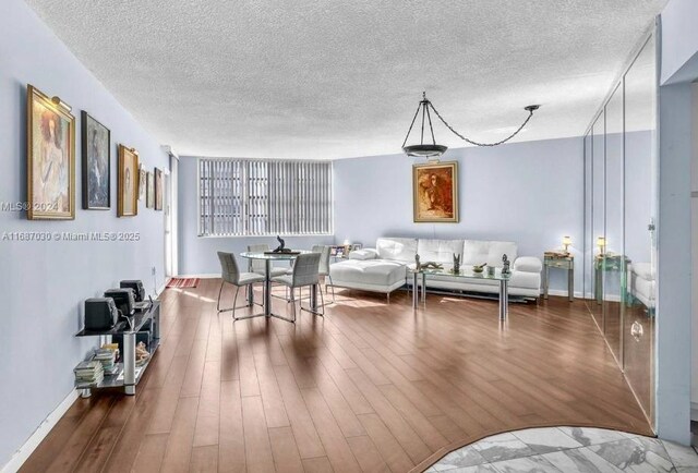 living room featuring hardwood / wood-style flooring and a textured ceiling