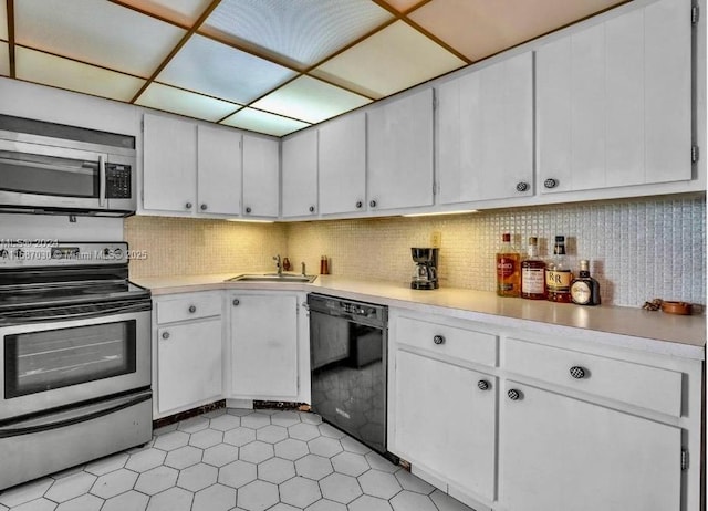 kitchen featuring white cabinetry, stainless steel appliances, sink, and tasteful backsplash