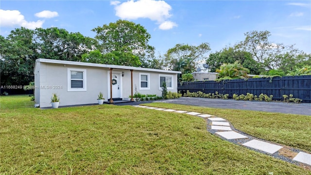 ranch-style home with a front lawn