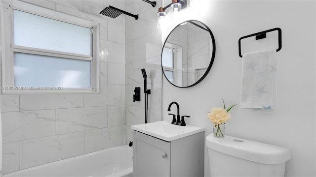 full bathroom with toilet, tiled shower / bath combo, and vanity