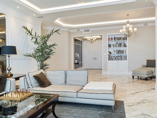 living room with ornamental molding, built in features, and a chandelier