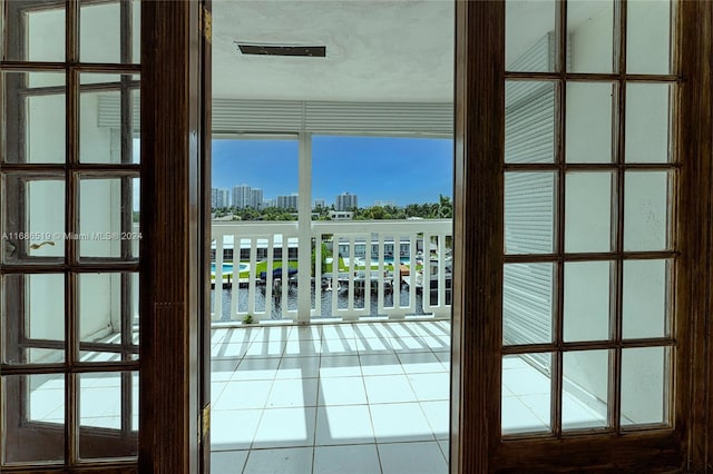 entryway featuring tile patterned flooring and a water view