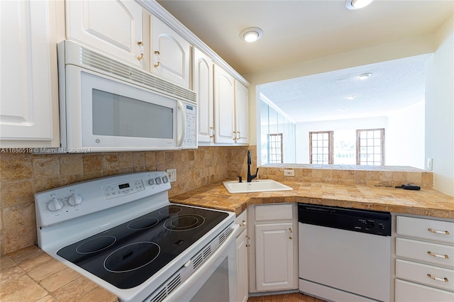 455 Paradise Isle Blvd Unit 402, Hallandale Beach, FL 33009 - kitchen featuring white appliances, a sink, and white cabinetry