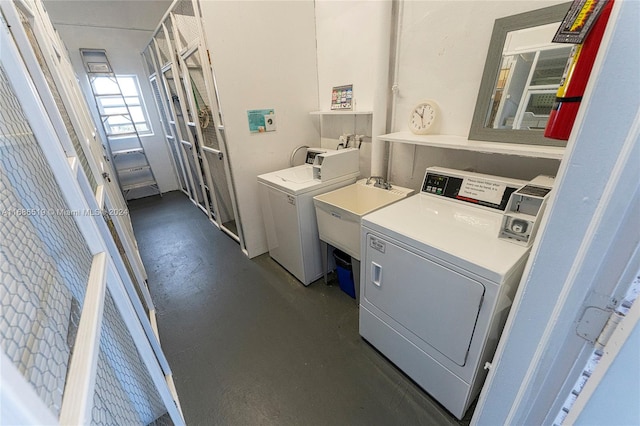 washroom with independent washer and dryer and sink