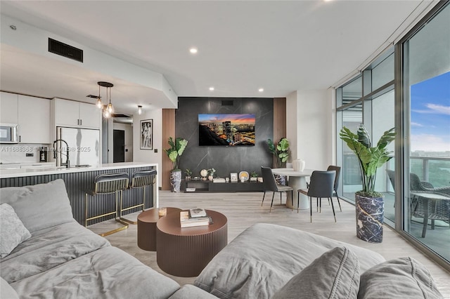 living room featuring light hardwood / wood-style flooring and expansive windows