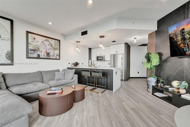 living room featuring light hardwood / wood-style flooring and sink