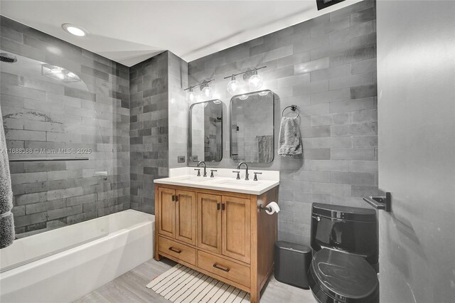 full bathroom with toilet,  shower combination, hardwood / wood-style floors, and vanity