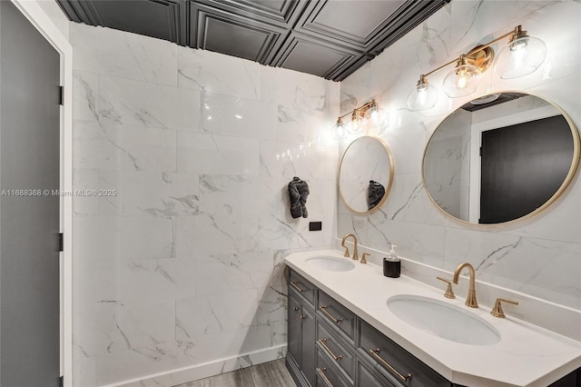 bathroom featuring vanity, tile walls, and hardwood / wood-style floors