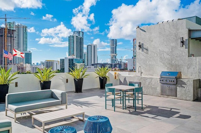 view of patio / terrace with an outdoor kitchen, outdoor lounge area, area for grilling, and sink