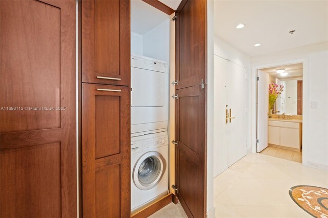 10175 Collins Ave Unit 1003, Bal Harbour, FL 33154 - washroom with stacked washing machine and dryer and recessed lighting